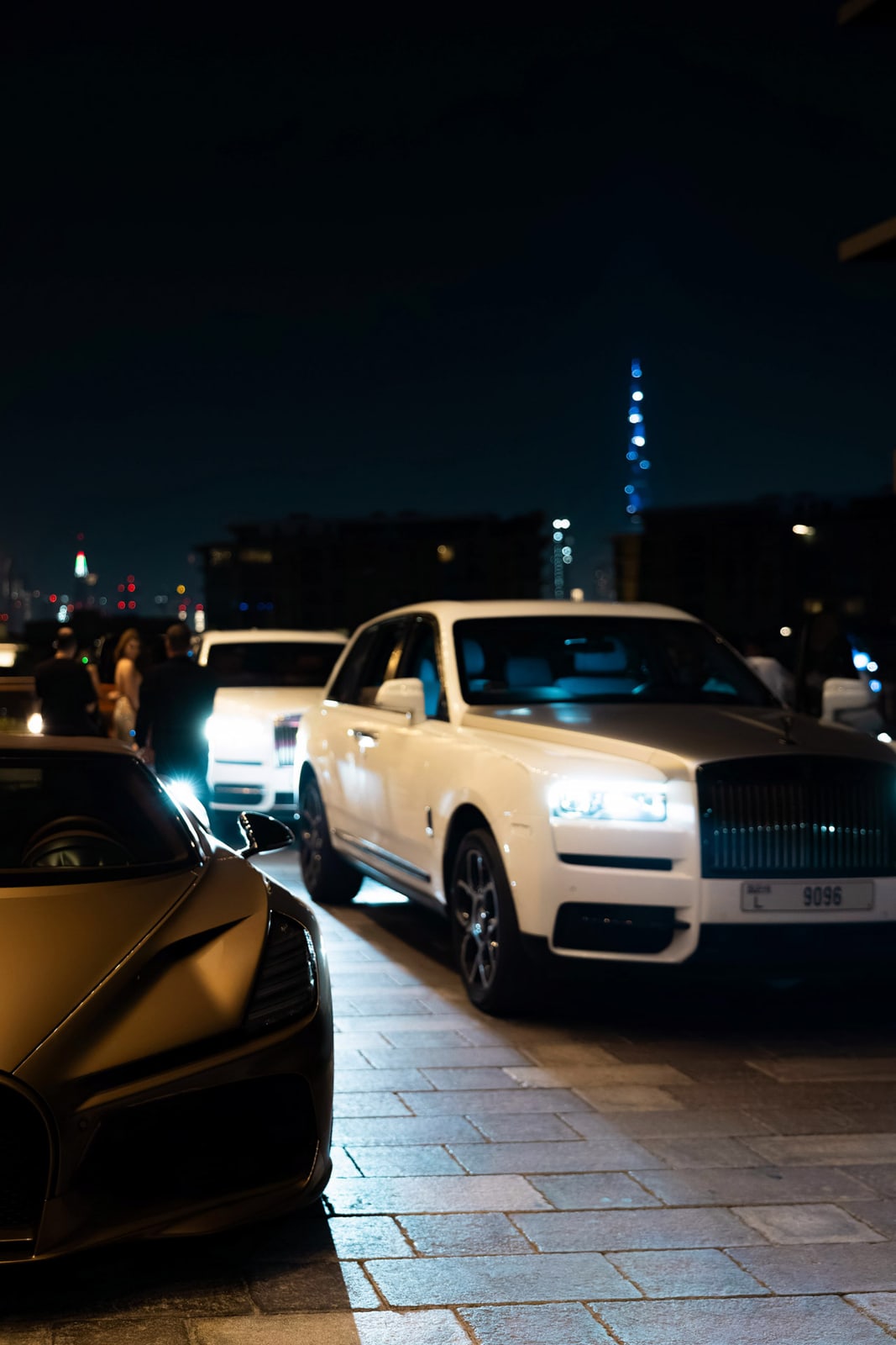 An evening vehicle arrival under city lights